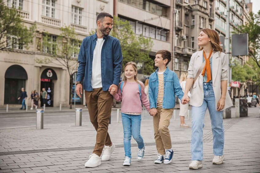 A family walking on a city sidewalk. 4