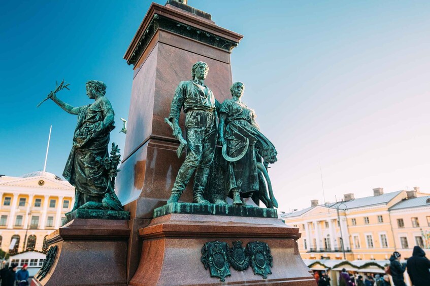 A bronze statue of a man and woman on a pedestal with a building in the background. 5
