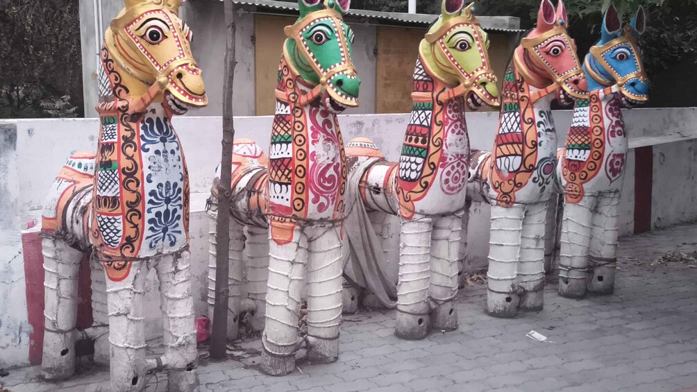 A row of colorful horse statues with intricate designs. 3