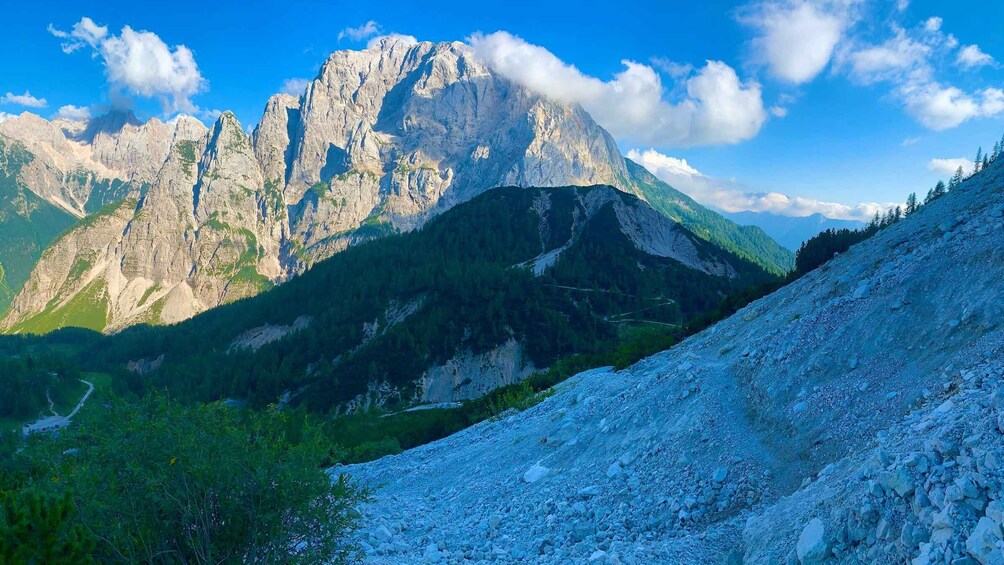 A mountain range with rocky terrain and green vegetation. 3