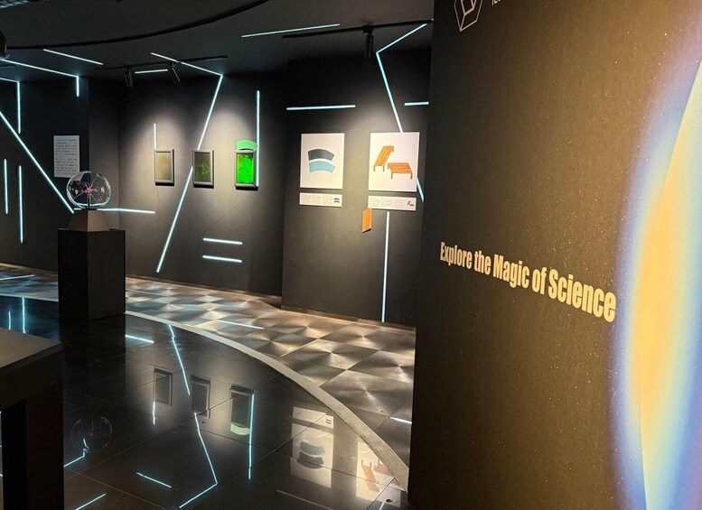 A modern science exhibit with interactive displays and a dark, futuristic design. 4