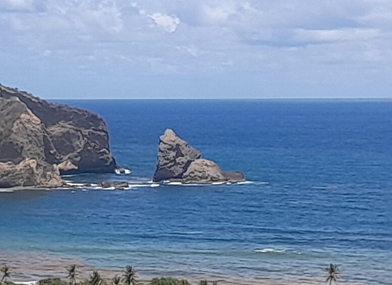 A coastal landscape with rocky formations and calm sea. 2