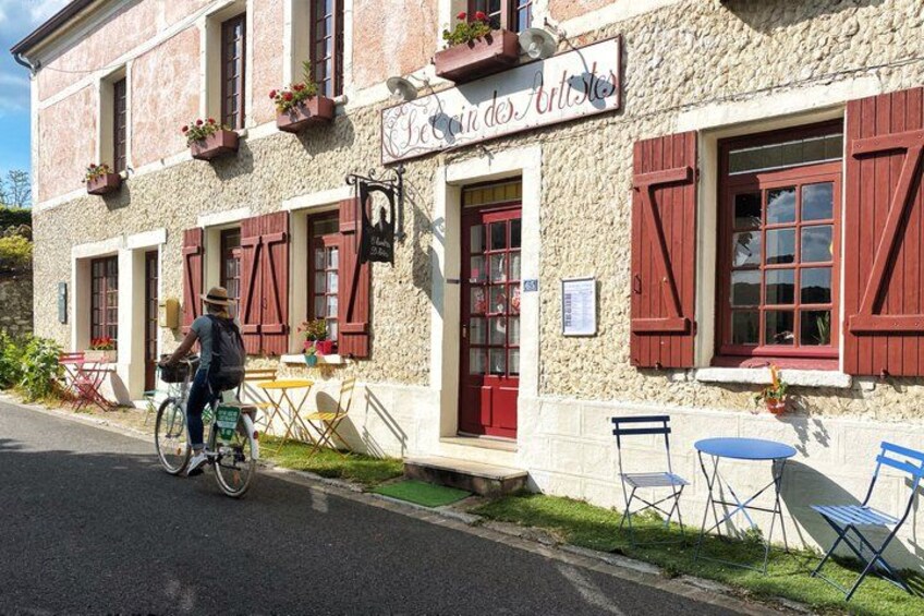 A building with red shutters and outdoor seating. 3