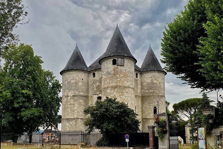 A historic stone castle with three towers and a gate. 2
