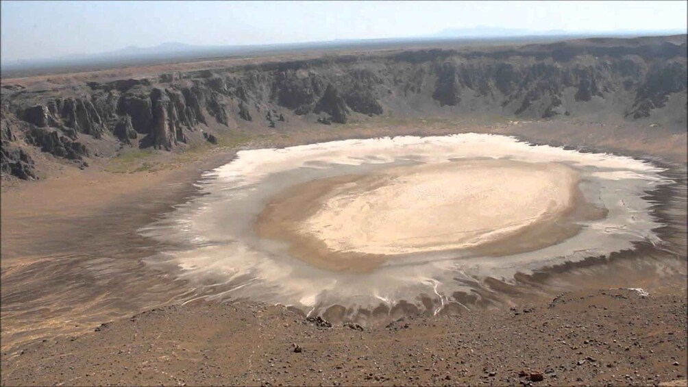 A large crater surrounded by a barren landscape. 3