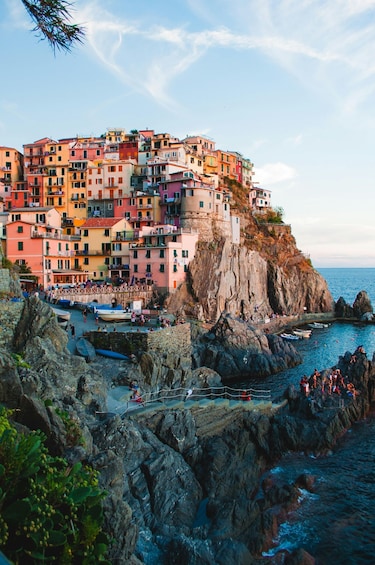 A coastal town with colorful buildings perched on a cliff overlooking the sea. 3