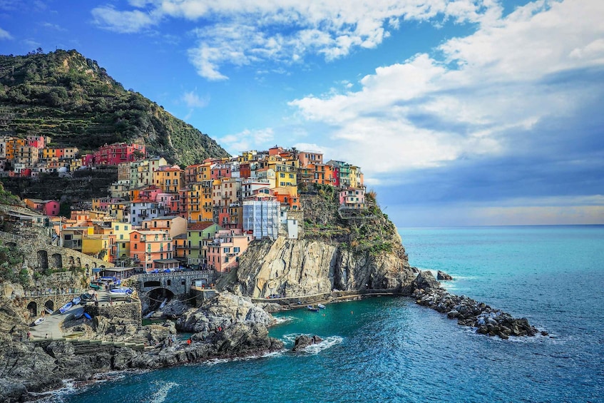 Colorful buildings on a cliff overlooking turquoise waters. 2