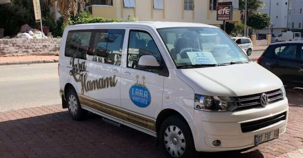 A white van with 'LARA' and 'LARA HAWAII' logos parked on a street. 3