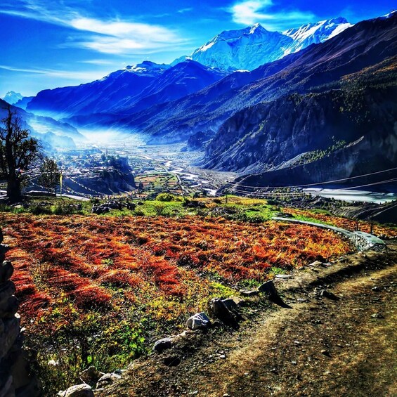A mountainous landscape with a valley, a river, and a road. 2
