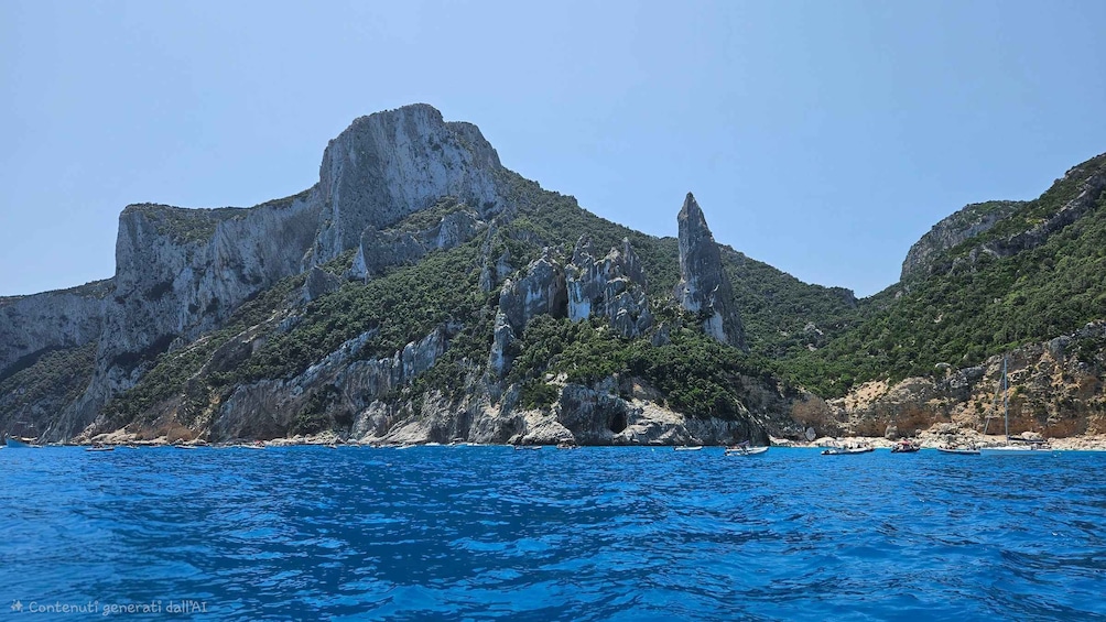 A coastal landscape with rocky cliffs and clear blue sea. 5