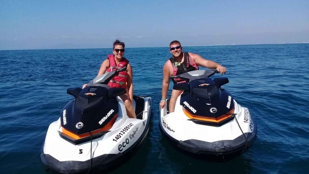 Two people on jet skis in the ocean. 2