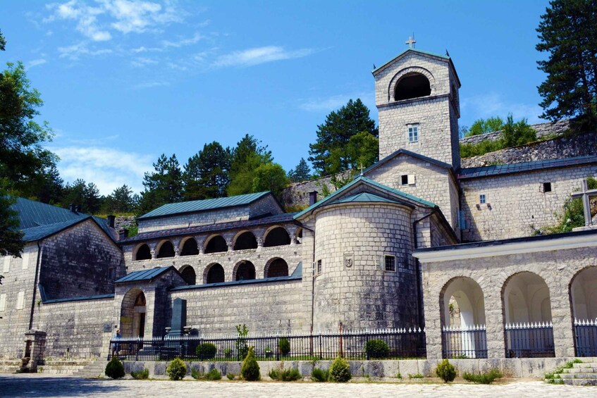 A historic stone building with a bell tower and arched windows. 4