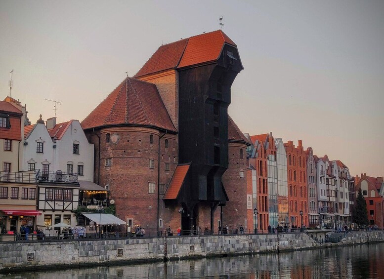A historic building with a unique black facade and red roof, surrounded by traditional European architecture. 3