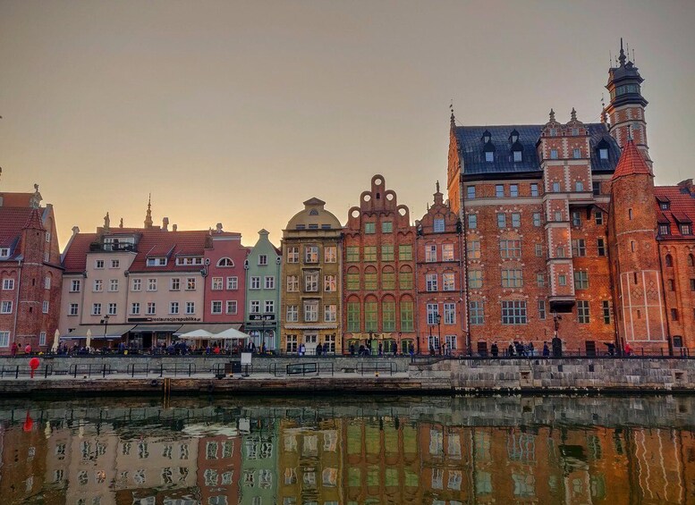 A riverside view of historic buildings with a bridge in the foreground. 2