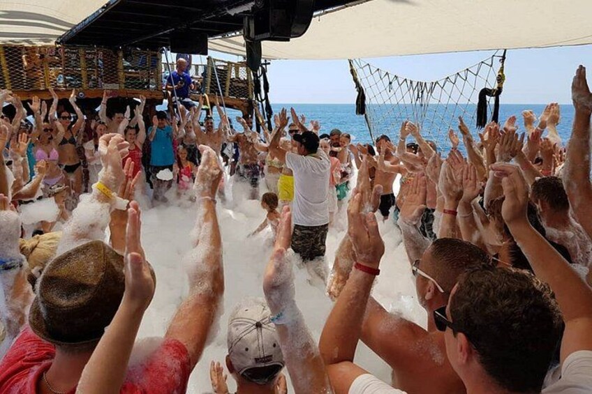 A group of people on a boat with their hands raised, possibly celebrating or cheering. 4