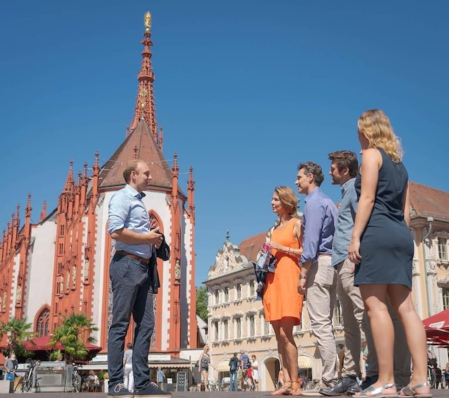 A group of people standing in front of a historic church with intricate architecture. 2