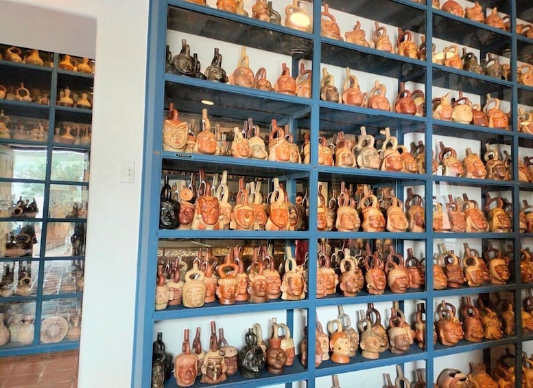 A display of various ceramic pottery items on shelves. 3