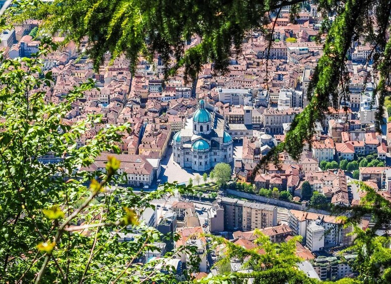 A cityscape with a prominent church featuring blue domes, surrounded by densely packed buildings. 5