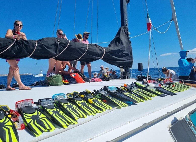 A group of people on a sailboat preparing for a diving excursion. 3