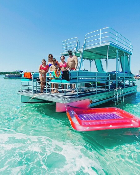 A group of people on a boat with a water slide. 2