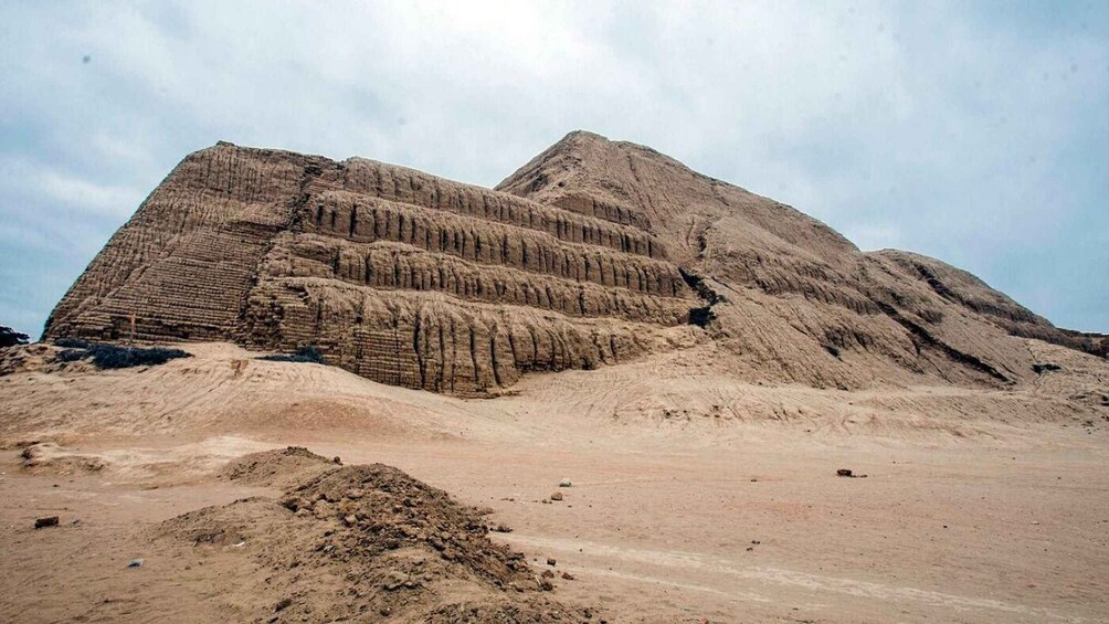 A large, tiered pyramid structure in a desert landscape. 3