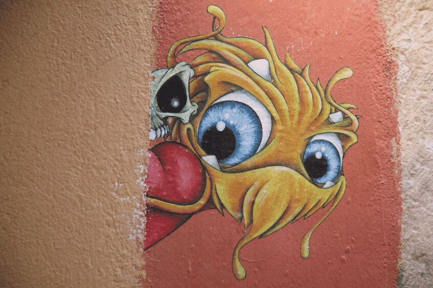 A colorful mural with a large eye and a skull. 5