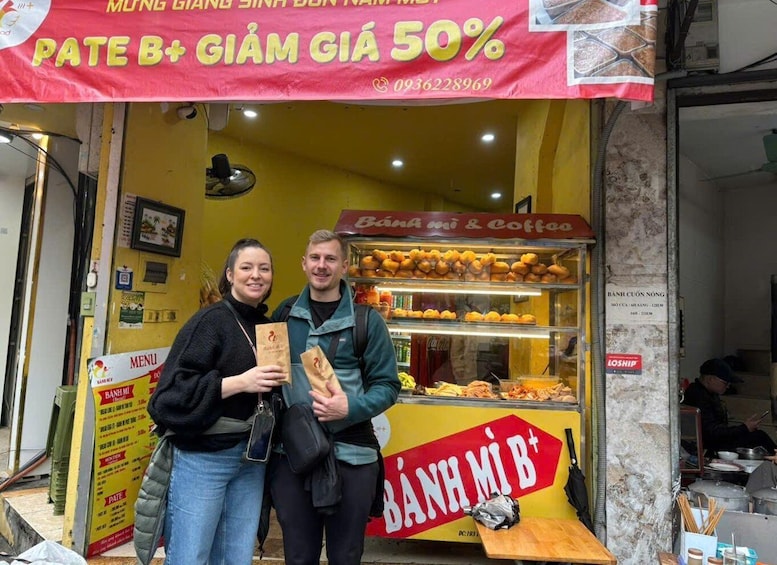 A street food stall with a sign offering B+ grade food at 50% discount. 5