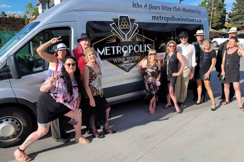 A group of people posing in front of a van with "Metropolis Wine Tours" branding. 2