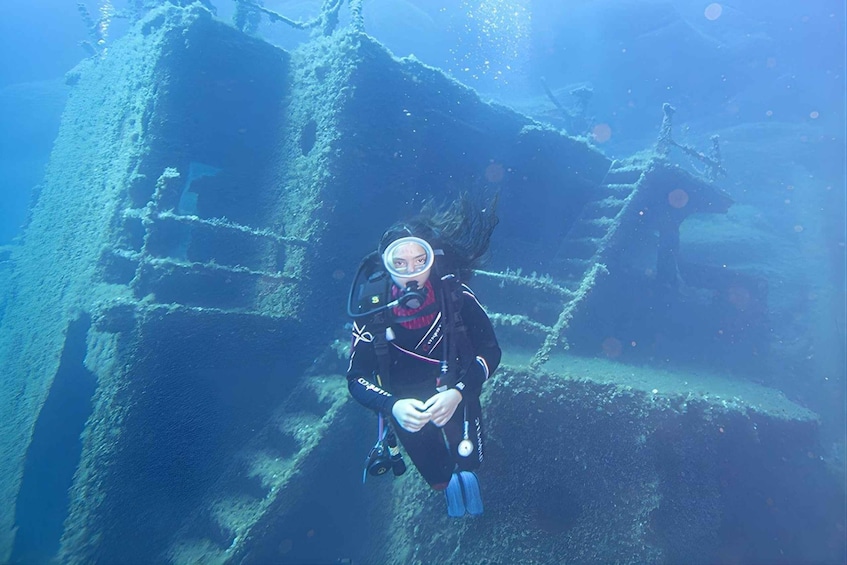 A diver exploring an underwater shipwreck. 2