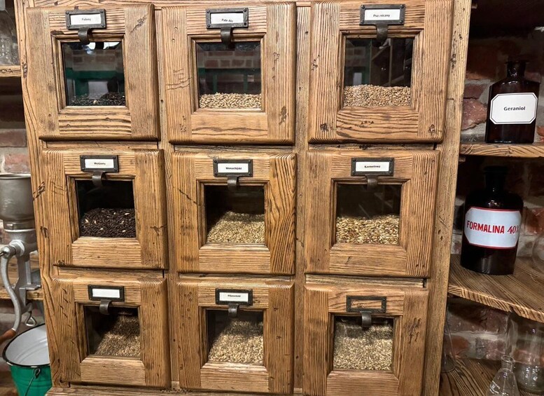 A wooden grain storage rack with labeled compartments containing different grains. 3