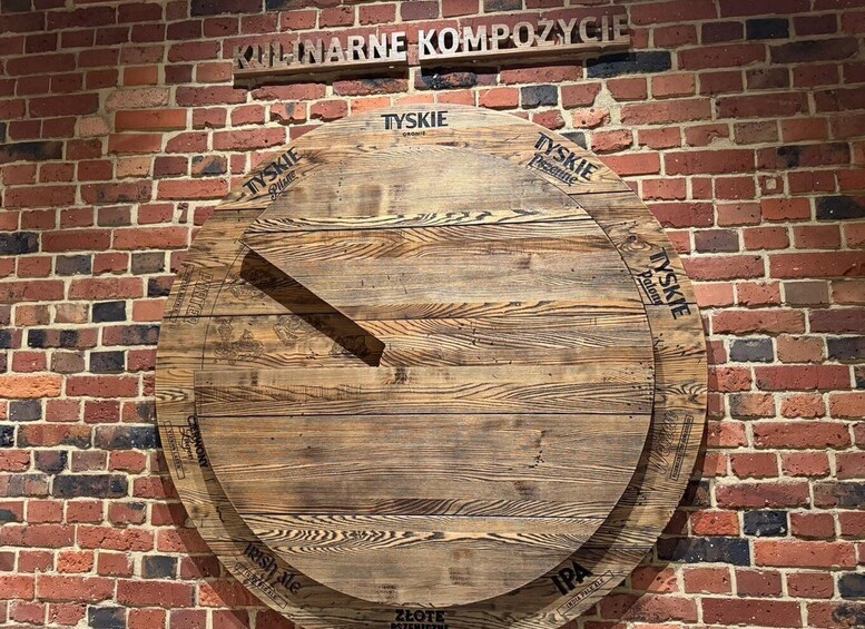 A wooden barrel with inscriptions and a brick wall background. 5