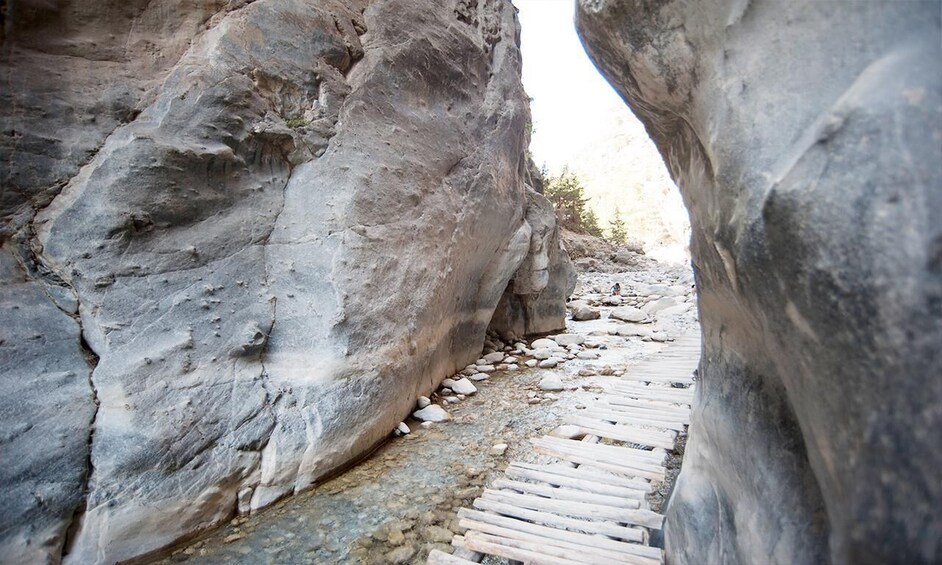A narrow rocky path between large boulders. 3