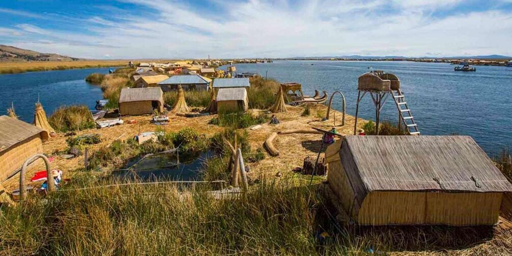 A riverside settlement with wooden structures and boats. 1