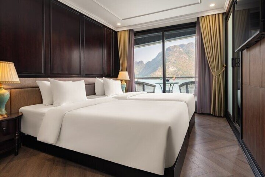 A hotel room with a large bed, two bedside tables, and a view of a mountainous landscape. 5