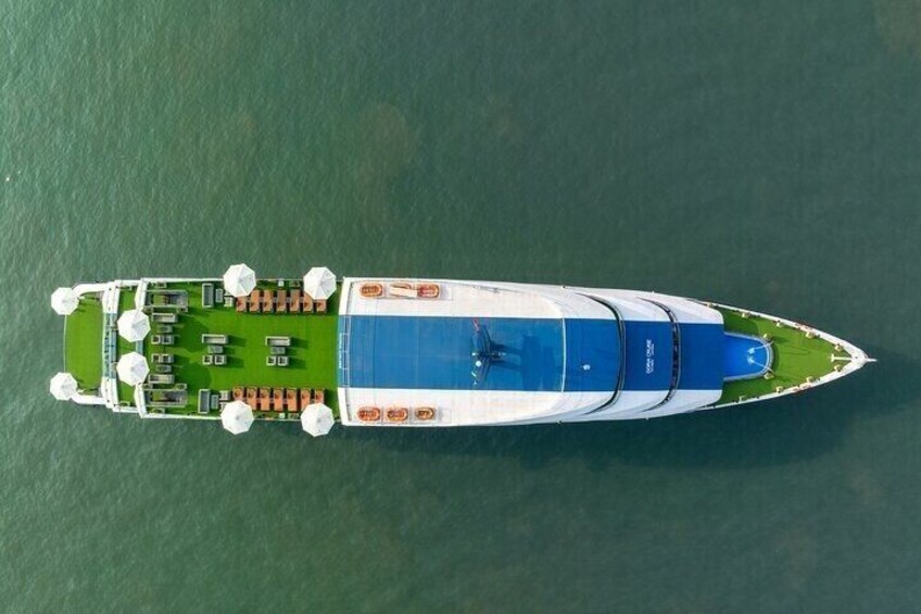 An aerial view of a yacht with a deck area, lounge chairs, and a swimming pool. 4