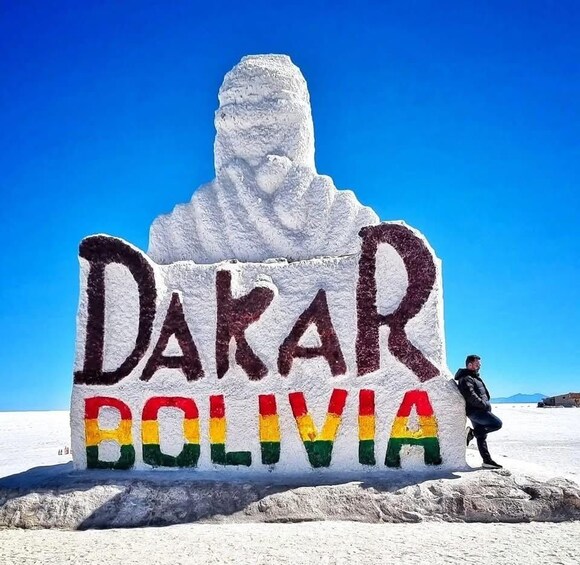 A snow sculpture of a man with the text 'Dakar Bolivia' painted on it. 2