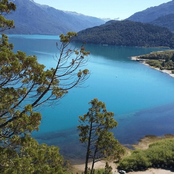 A lake surrounded by mountains and trees. 2