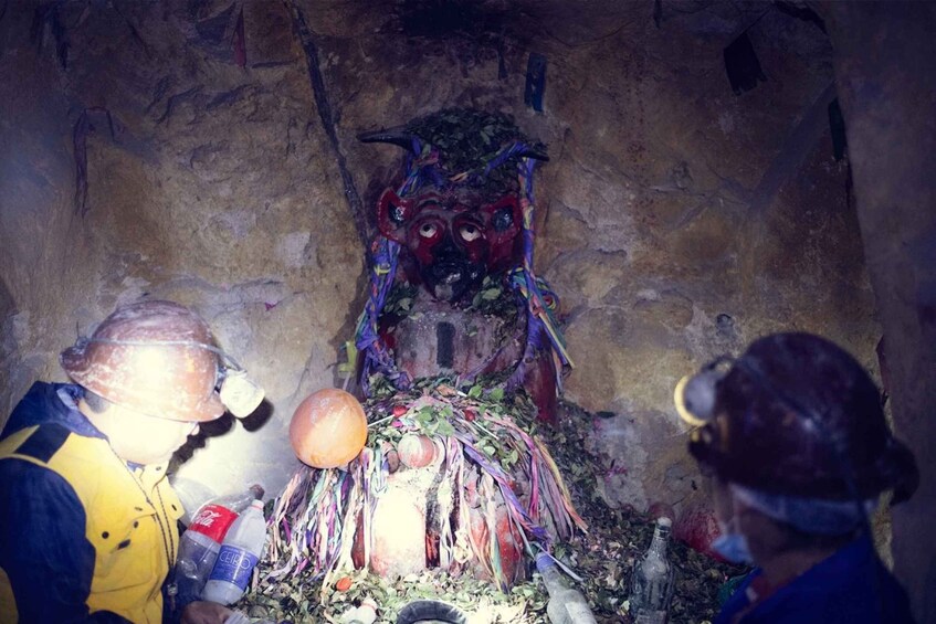 A cave with a colorful, painted face on the wall. 3
