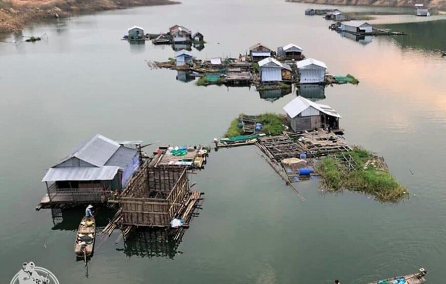 A cluster of floating houses on a calm body of water. 2