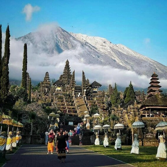 A temple complex with a snow-capped mountain in the background. 1
