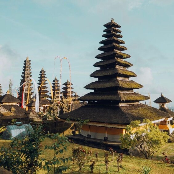 A traditional Balinese temple with tiered roofs and a thatched structure. 5