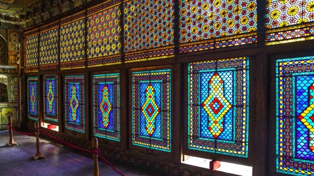 A series of colorful stained glass windows with geometric patterns. 4