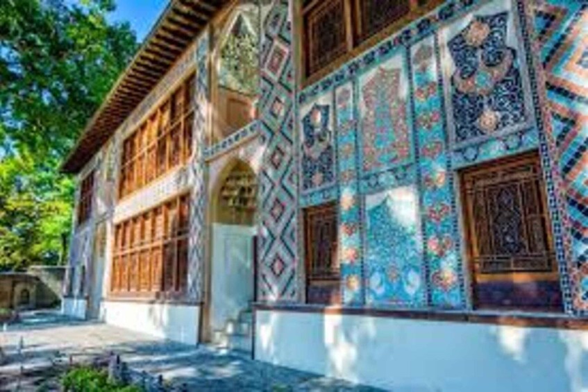 A building with intricate tile work and wooden window frames. 5