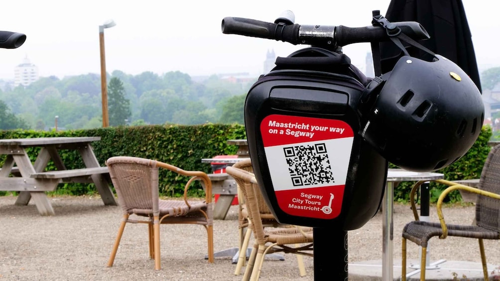 A Segway with a QR code and a helmet attached to it. 4