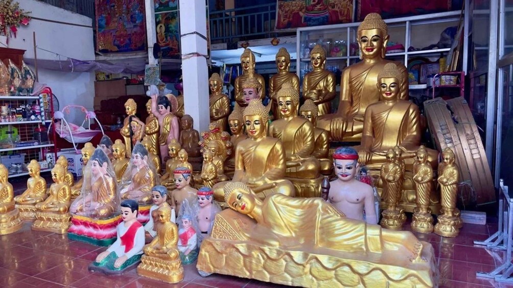 A collection of golden Buddha statues in various sizes and poses. 4