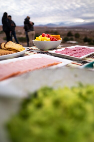 A table with various food items and a bowl of fruit. 4