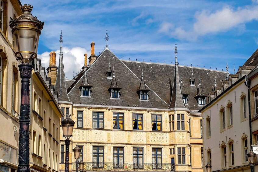 A historic building with ornate facades and a steeply pitched roof. 5
