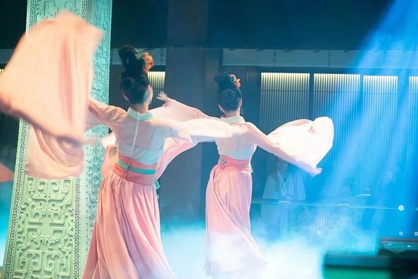 Two dancers in pink costumes performing a traditional dance. 5