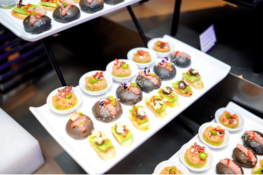A variety of appetizers arranged on white trays. 5