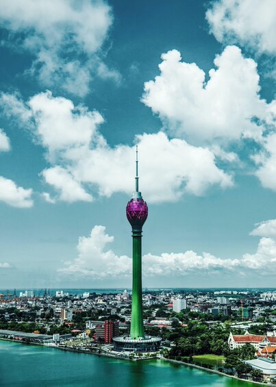 A tower with a spherical observation deck, surrounded by a cityscape and a body of water. 2